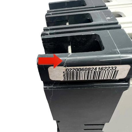Black plastic component with a barcode label and red arrow pointing to it on a white background