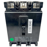 Black electrical circuit breaker with a label on a white background