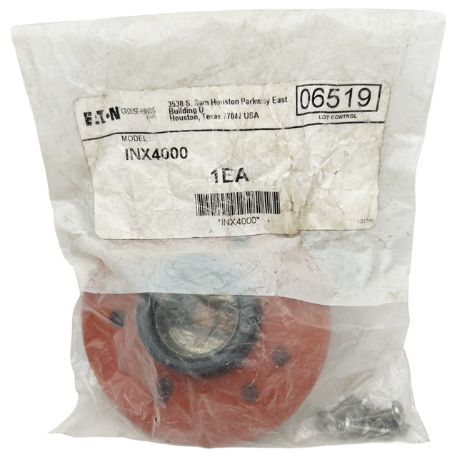 Red mechanical component in a clear plastic bag with EATON label