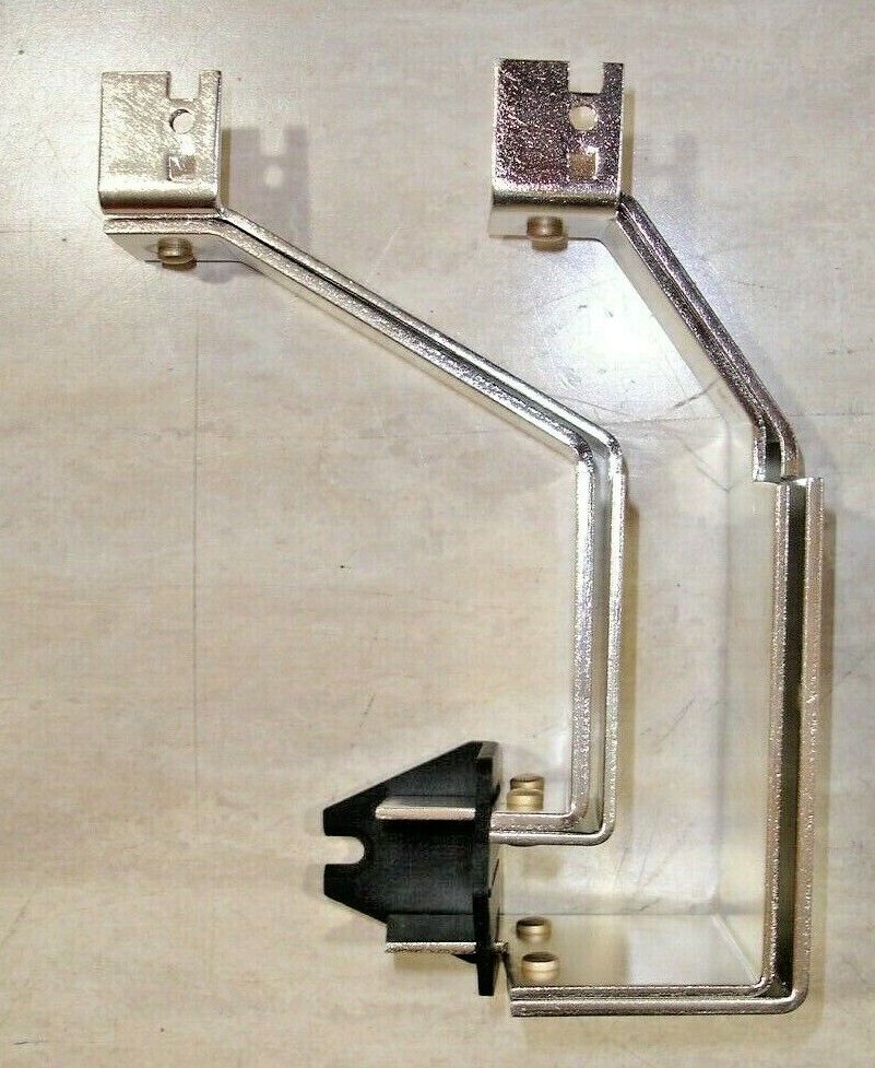 A silver-colored metal meter socket breaker buss replacement kit laid on a flat surface.