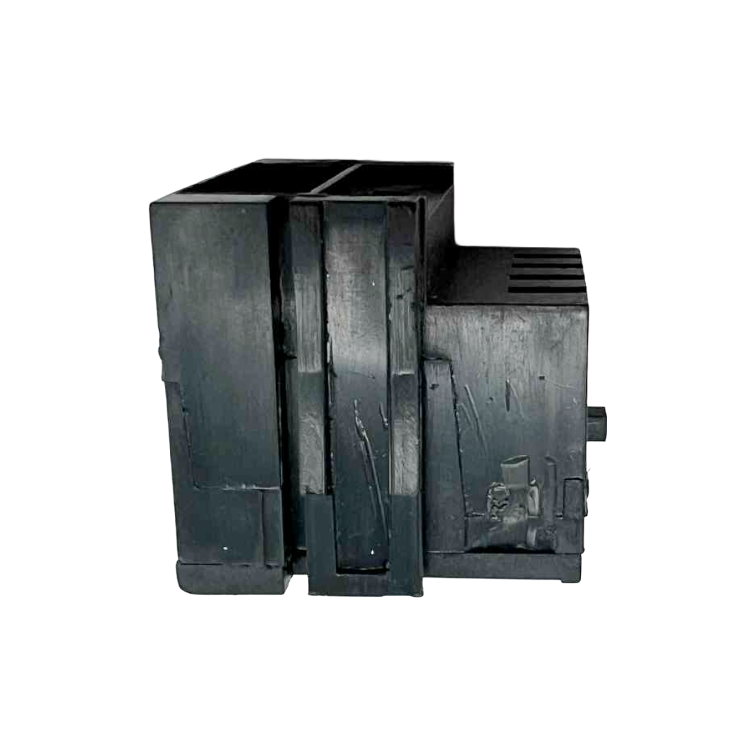 Black plastic component on a white background