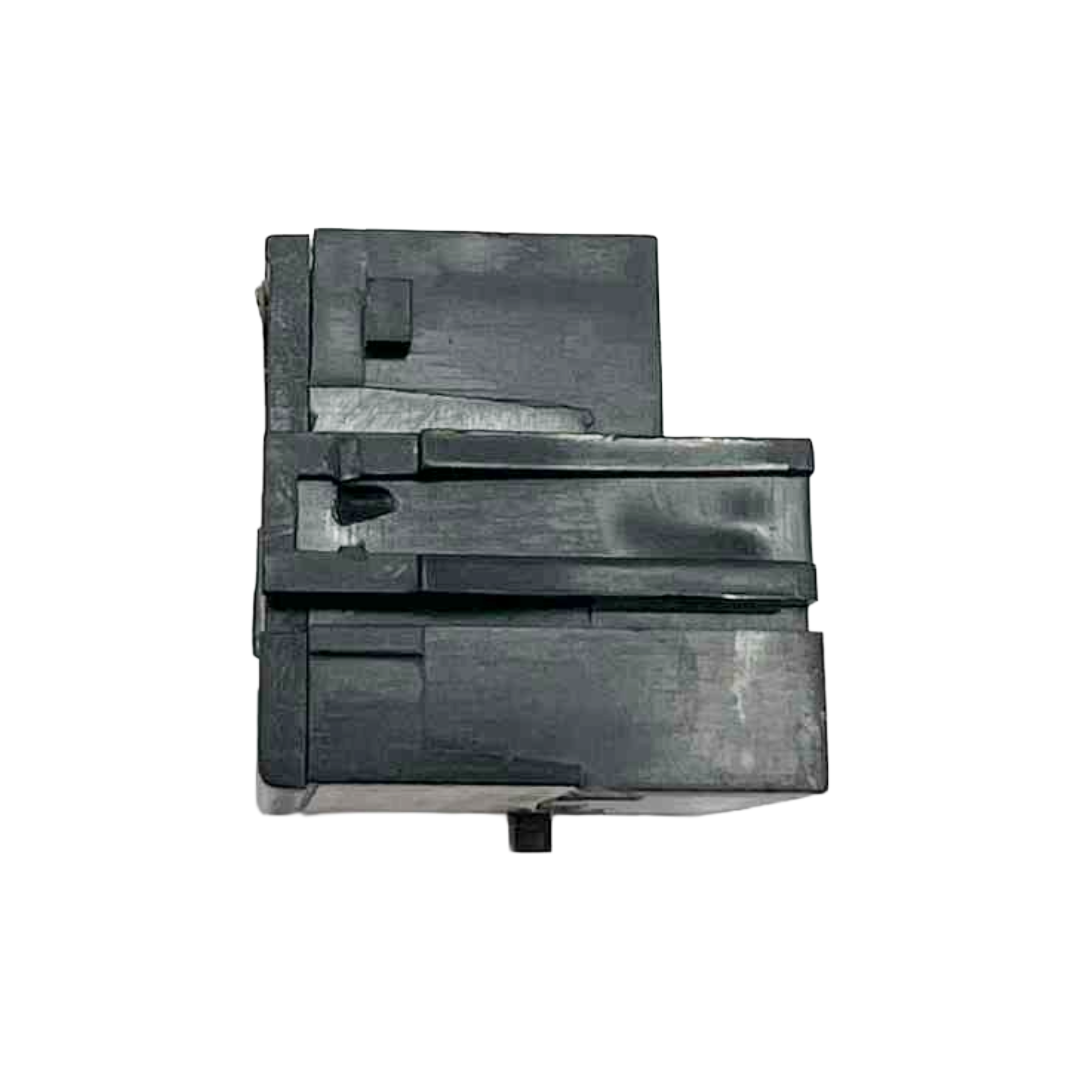 Black plastic component on a white background