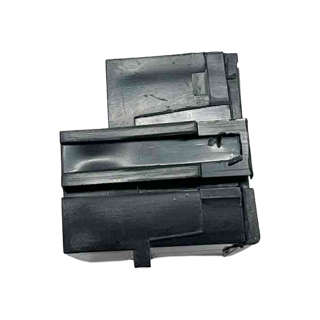 Black plastic component on a white background