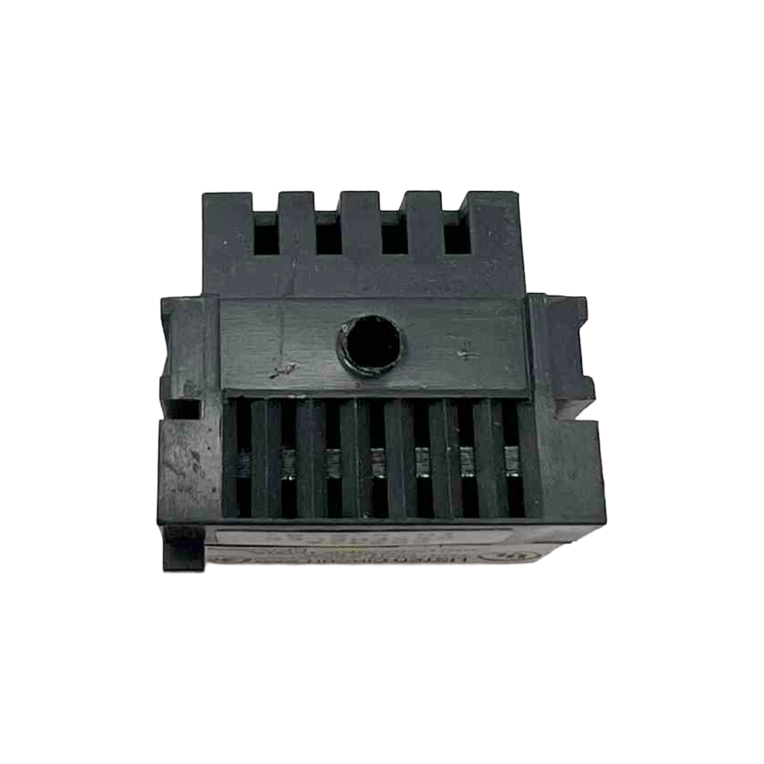 Black plastic component with grooves on a white background