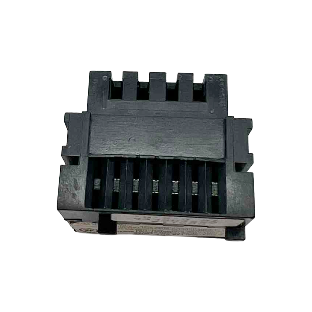 Black plastic component with grooves on a white background