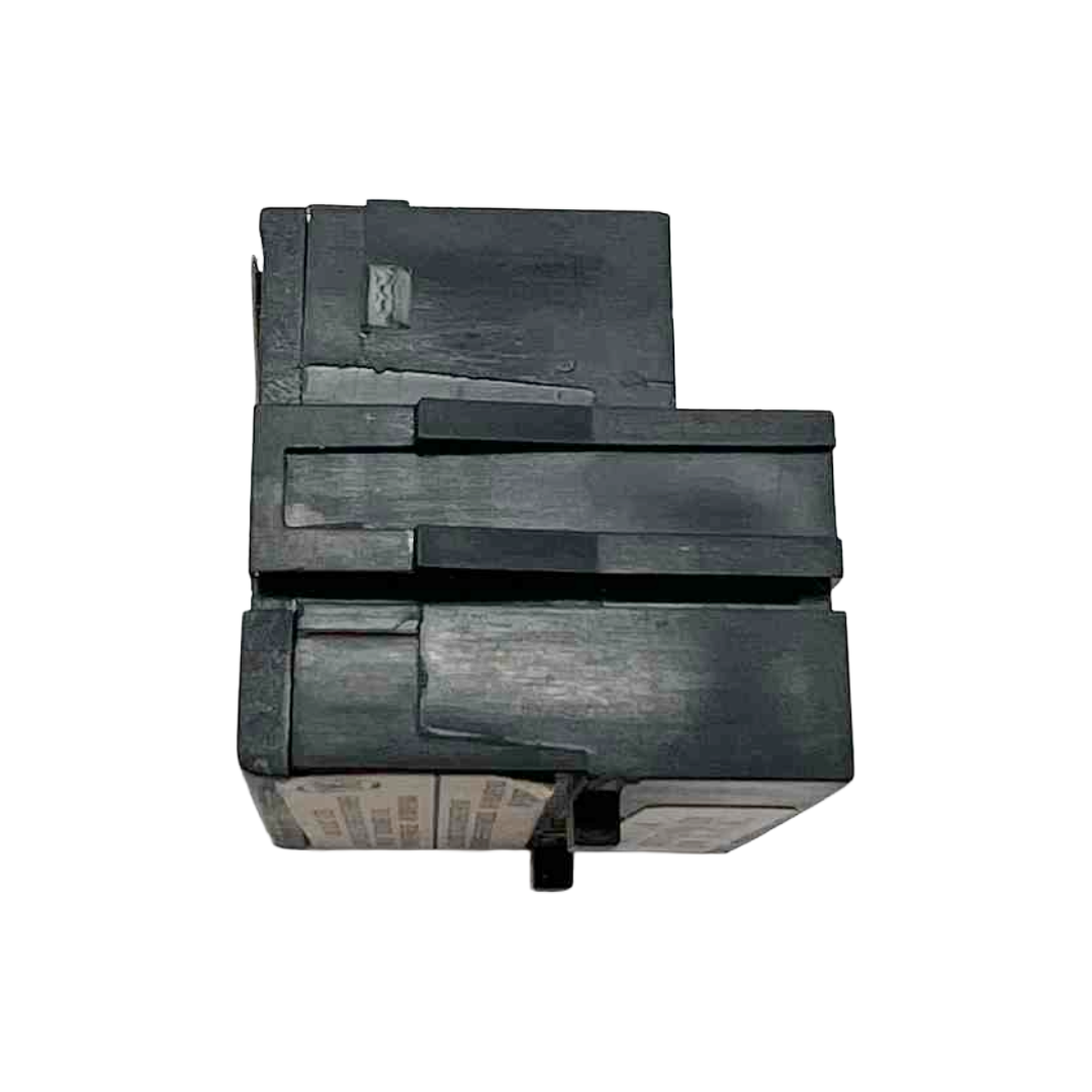 Black plastic component on a white background