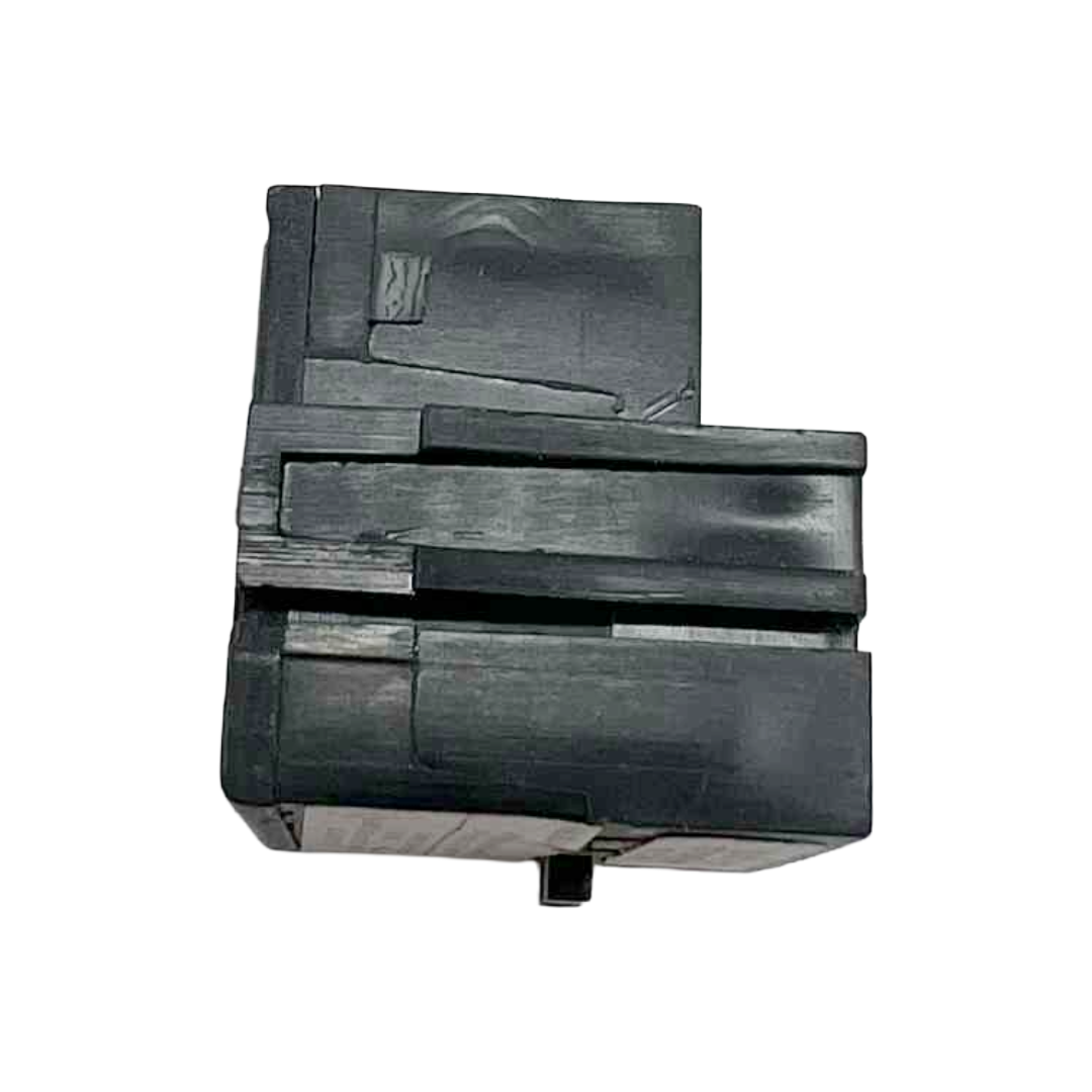 Black plastic component on a white background