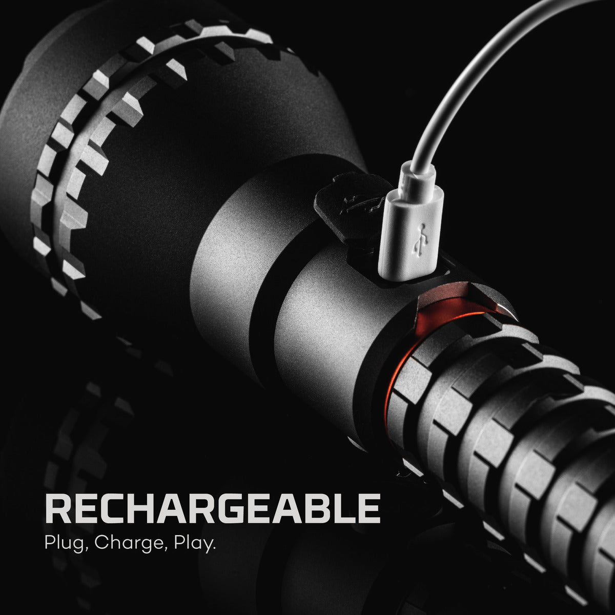 Close-up of a rechargeable device with USB cable on a black background