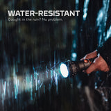 Person holding a flashlight in the rain with 'WATER-RESISTANT' text above.
